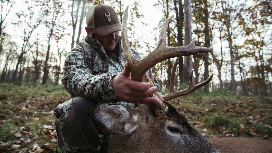 male hunter holding deer kill