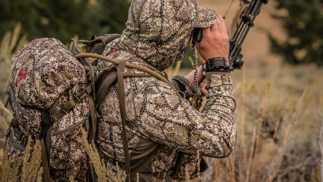 man using binoculars during warm hunt