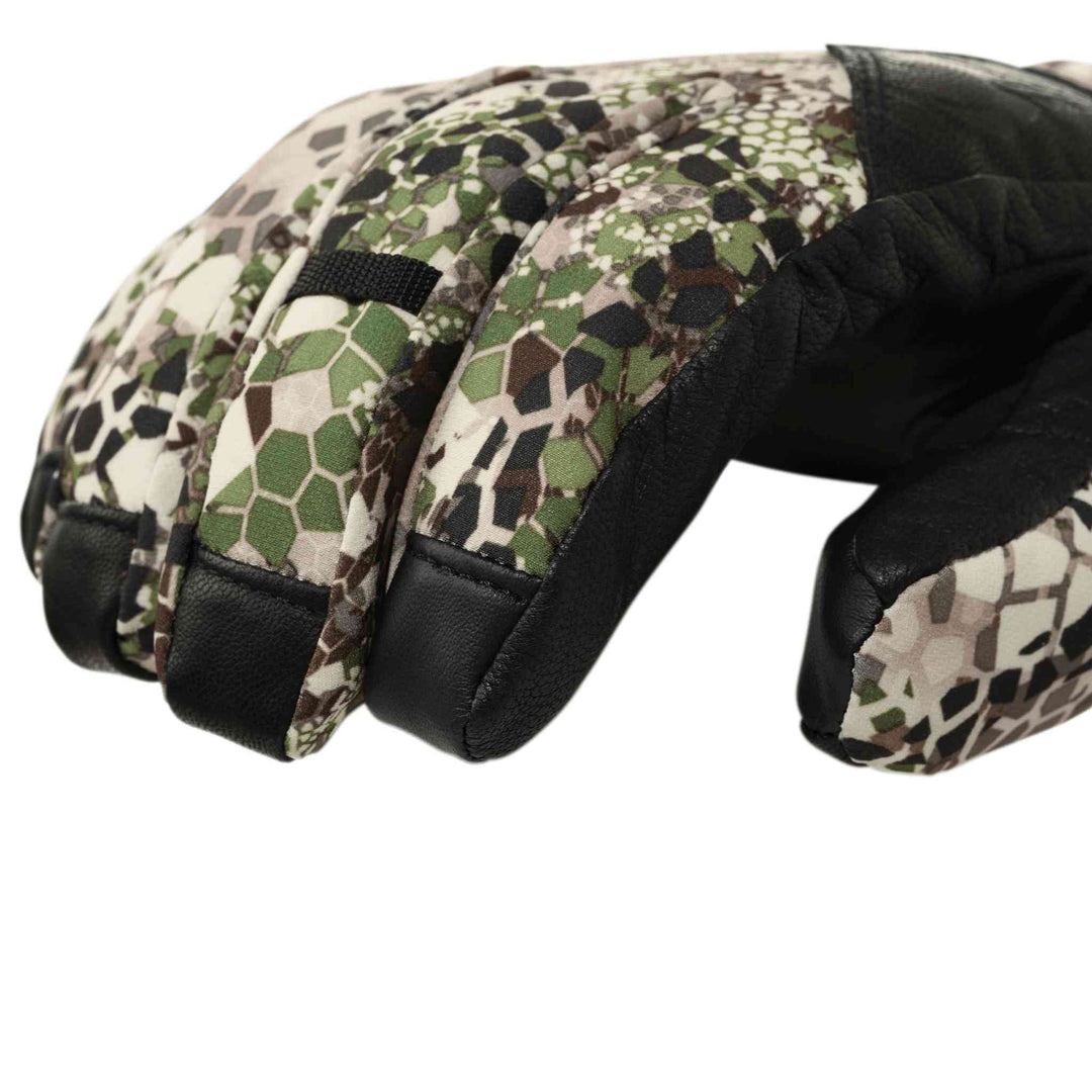 Close-up of a Badlands camo hunting glove with black leather accents; no visible Badlands skull logo.