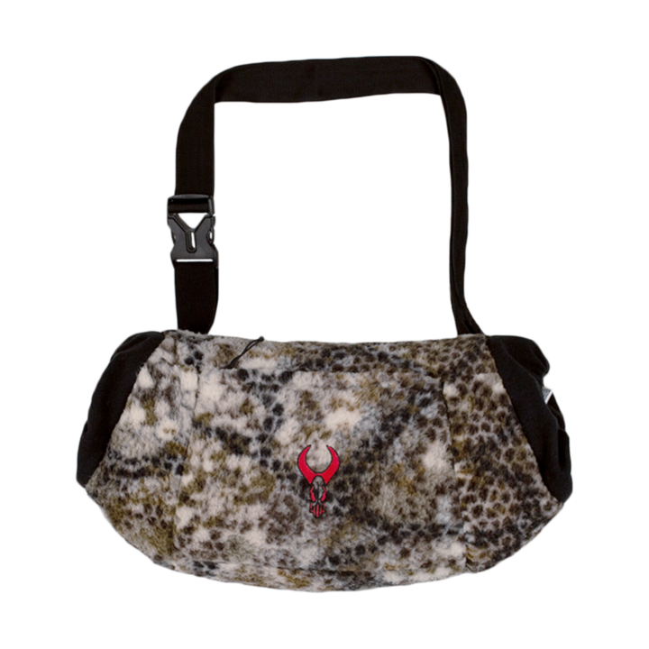 Camo fleece hand muff with adjustable strap and red Badlands skull logo on front. Ideal for cold-weather hunting.