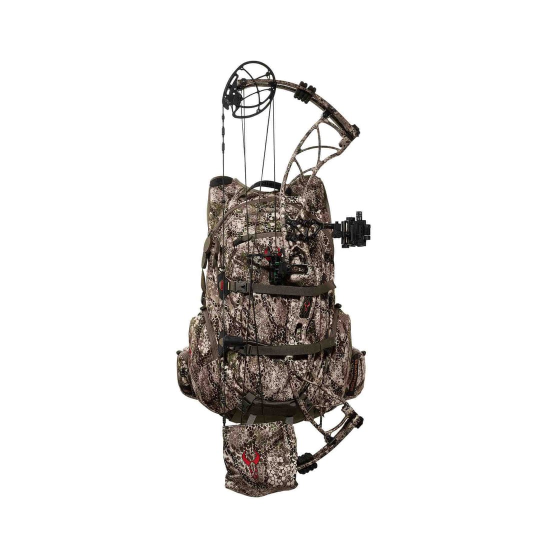 Camo Badlands hunting backpack with bow holder and red Badlands skull logo on front pouch, shown against a white background.