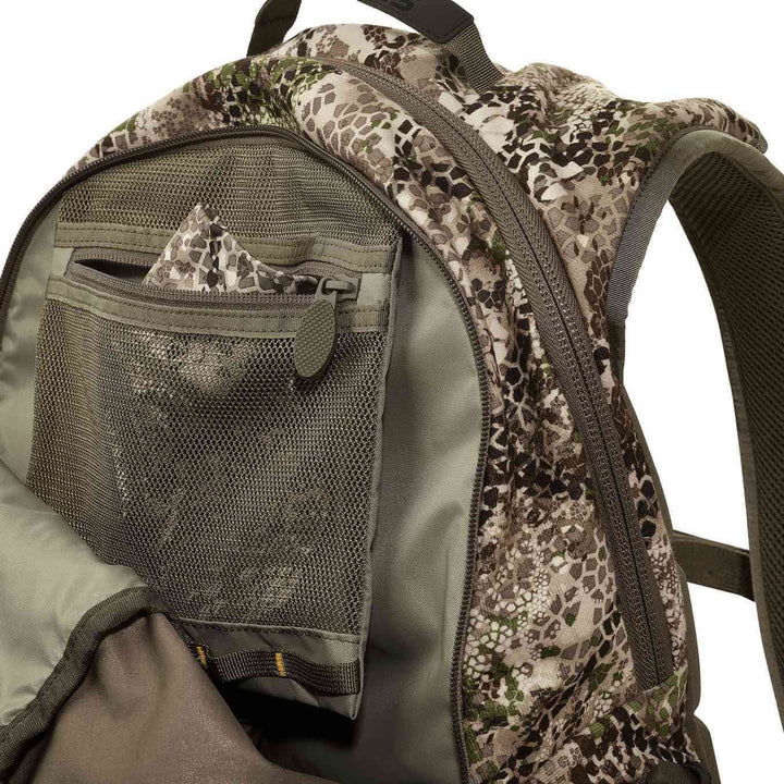 Badlands camo backpack with mesh pocket and zipper, featuring the Badlands skull logo on the inner fabric.