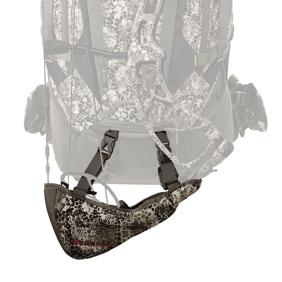 Badlands camo rifle boot attached to a backpack; features Badlands logo with skull on the side.