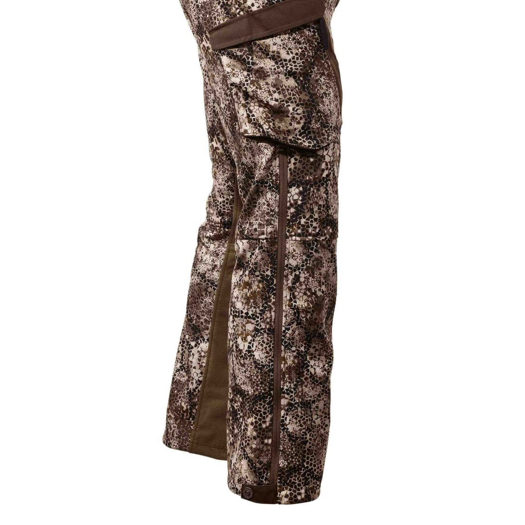 Badlands camo hunting pants with side cargo pocket and zipper, featuring the Badlands skull logo on the cuff.