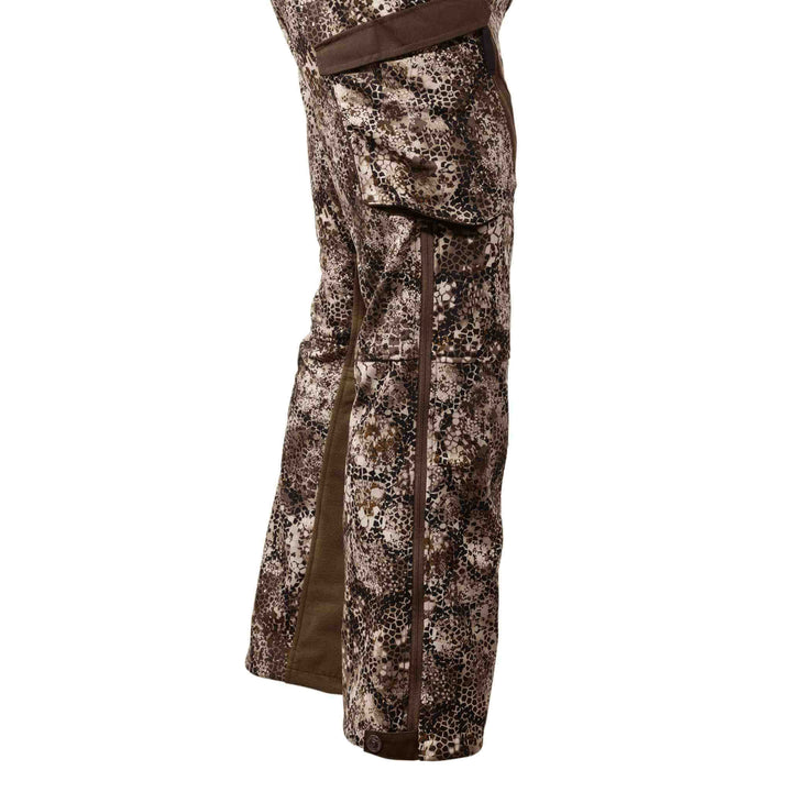 Badlands camo hunting pants with side cargo pocket and zipper, featuring the Badlands skull logo on the cuff.