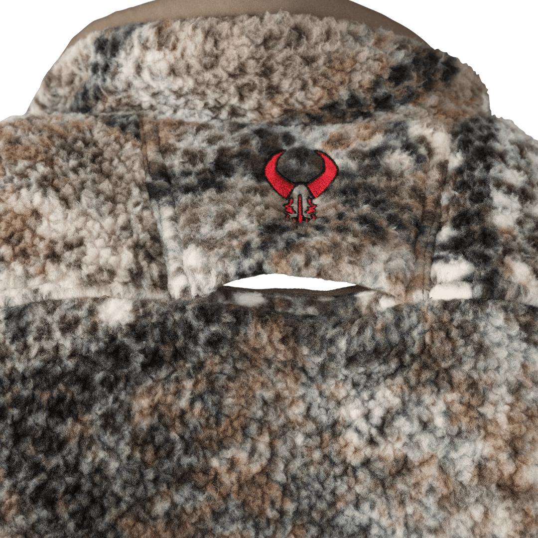 Close-up of Badlands fleece jacket in camo pattern, featuring embroidered red skull logo on the back yoke.