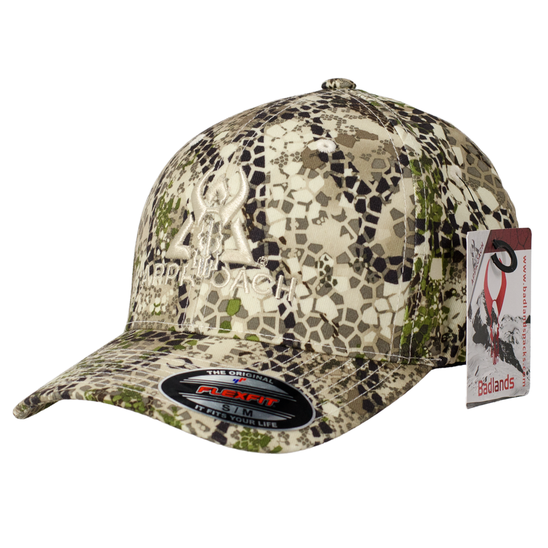 Badlands camo cap with Flexfit tag and embroidered skull logo; includes attached Badlands logo tag.