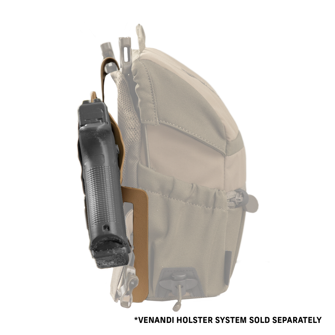 Badlands holster with logo skull, attached to a tan pack; holds a black handgun for secure, accessible carry.