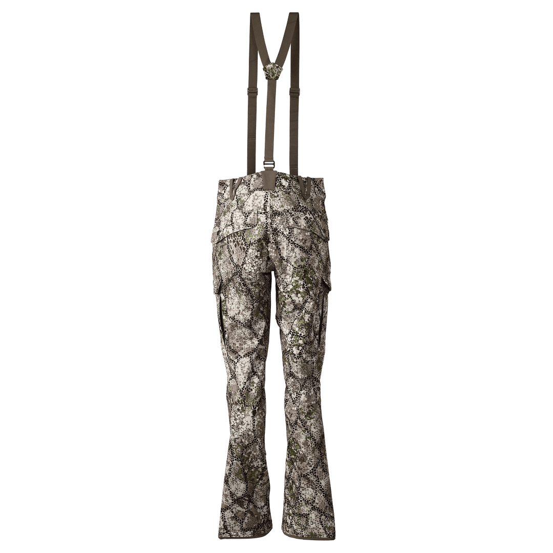 Rear view of Badlands camo hunting pants with suspenders and Badlands skull logo on the waistband.