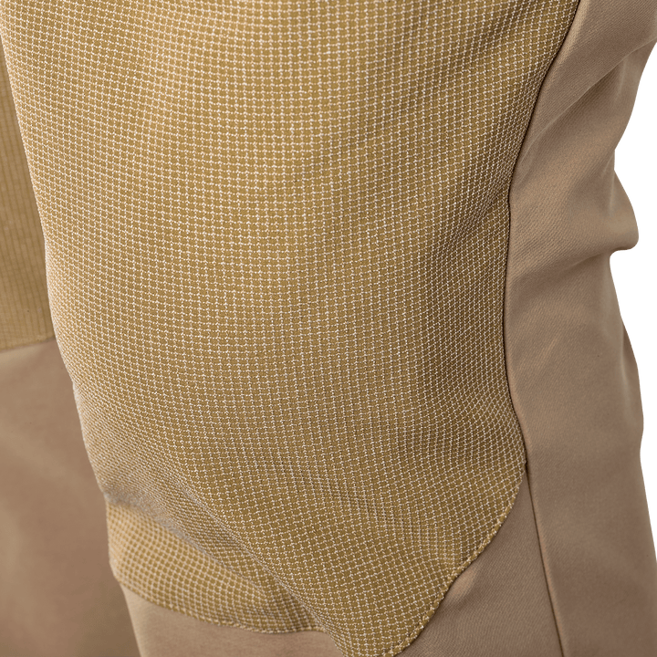 Close-up of Badlands pants knee area, showing reinforced tan fabric with grid pattern for durability.
