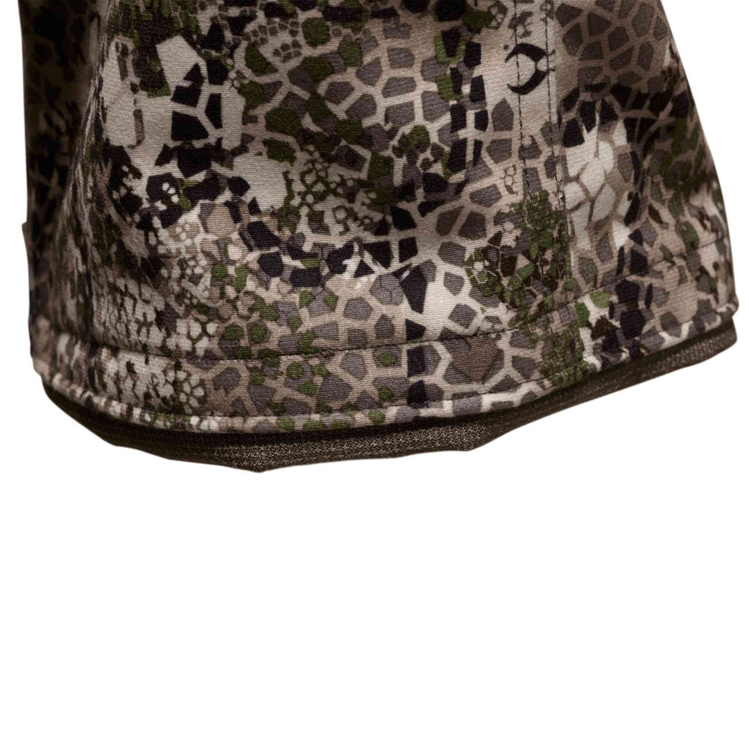 Close-up of Badlands camo fabric with stitched hem and subtle Badlands skull logo pattern.