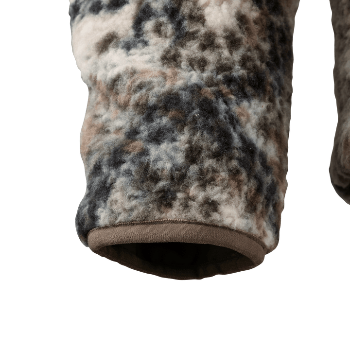 Close-up of a Badlands camo fleece sleeve with soft texture and earth-tone pattern.