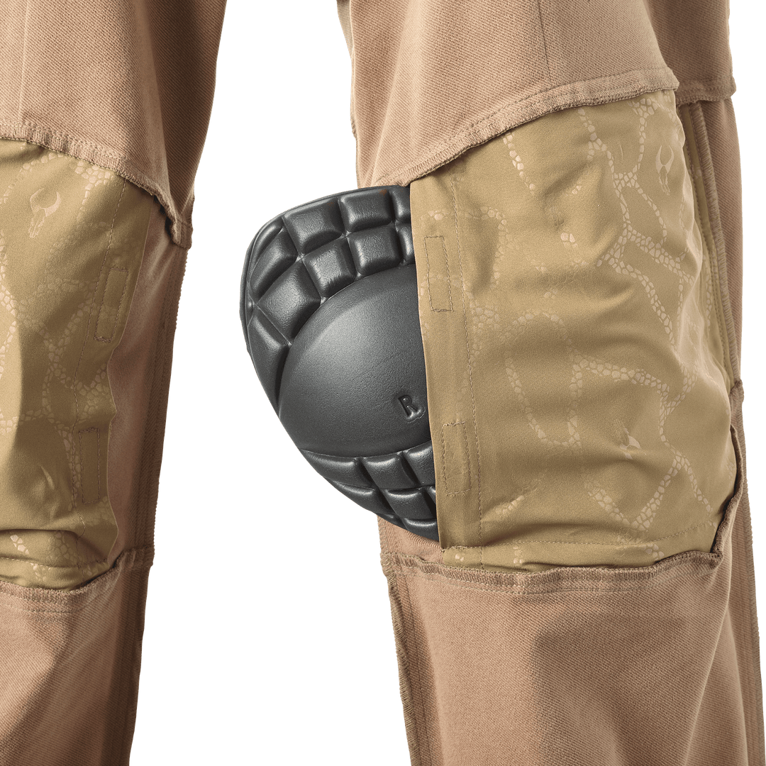 Close-up of Badlands pants with knee pad inserted; subtle Badlands skull logo visible on fabric.