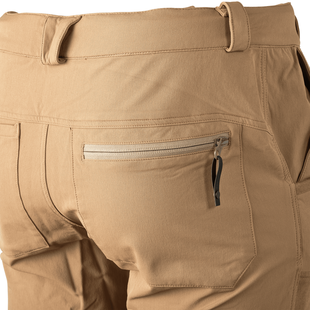 Close-up of tan Badlands pants back pocket with zipper and pull tab, showing durable stitching and accessible storage.