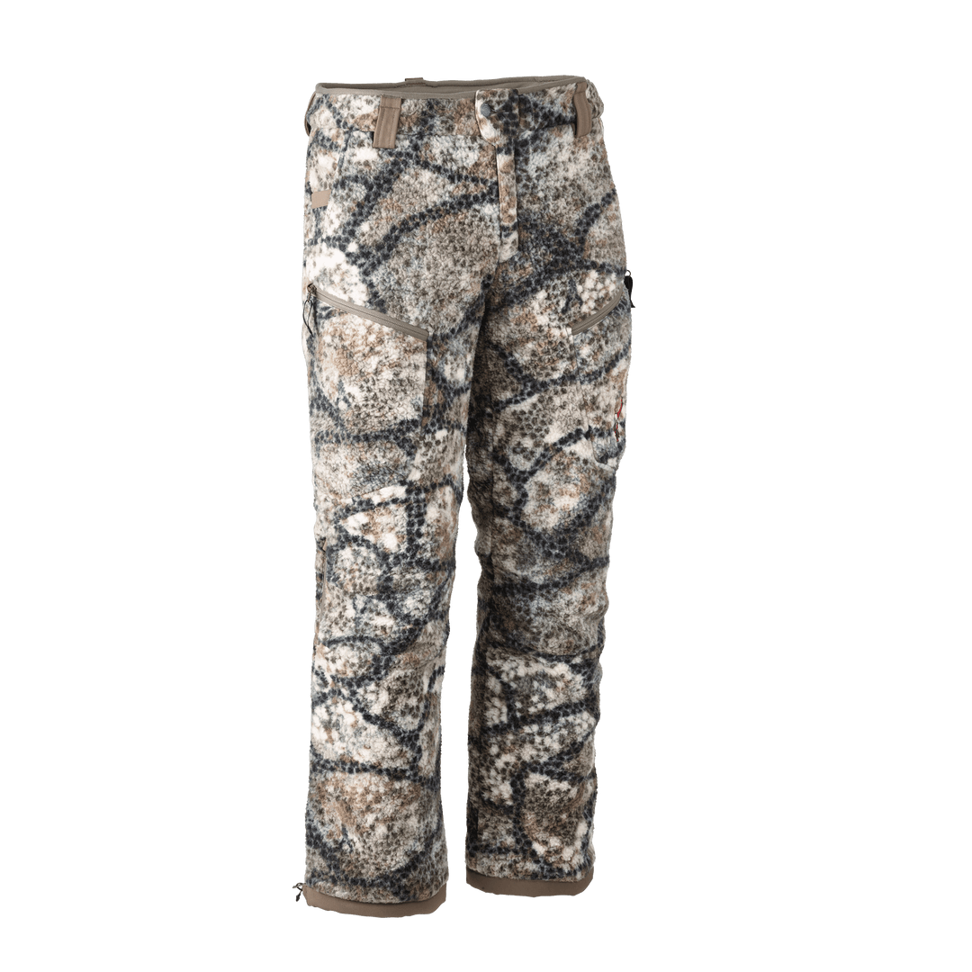 Badlands camo hunting pants with cargo pockets and Badlands skull logo on right leg, shown on white background.