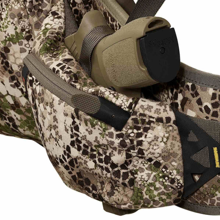 Badlands camo pack with holstered SIG SAUER pistol; Badlands skull logo visible on the right side.