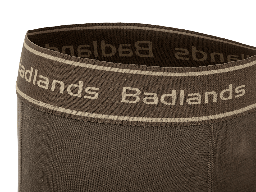 Close-up of brown Badlands underwear waistband with logo in tan, showing soft, stretchy fabric and flat seams.
