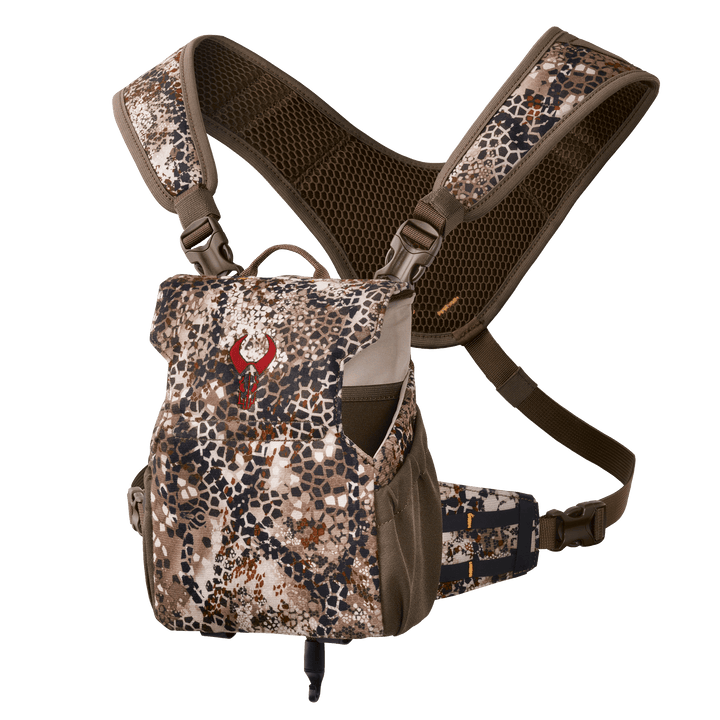 Badlands camo binocular harness with red skull logo, padded straps, and mesh backing for comfort and support.