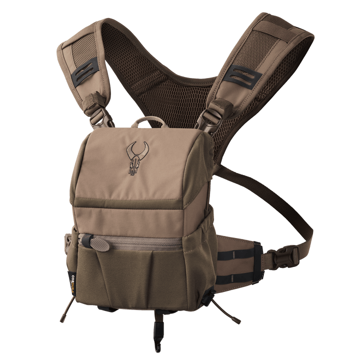 Tan Badlands chest pack with logo skull, adjustable straps, zippered front pocket, and breathable mesh back panel.