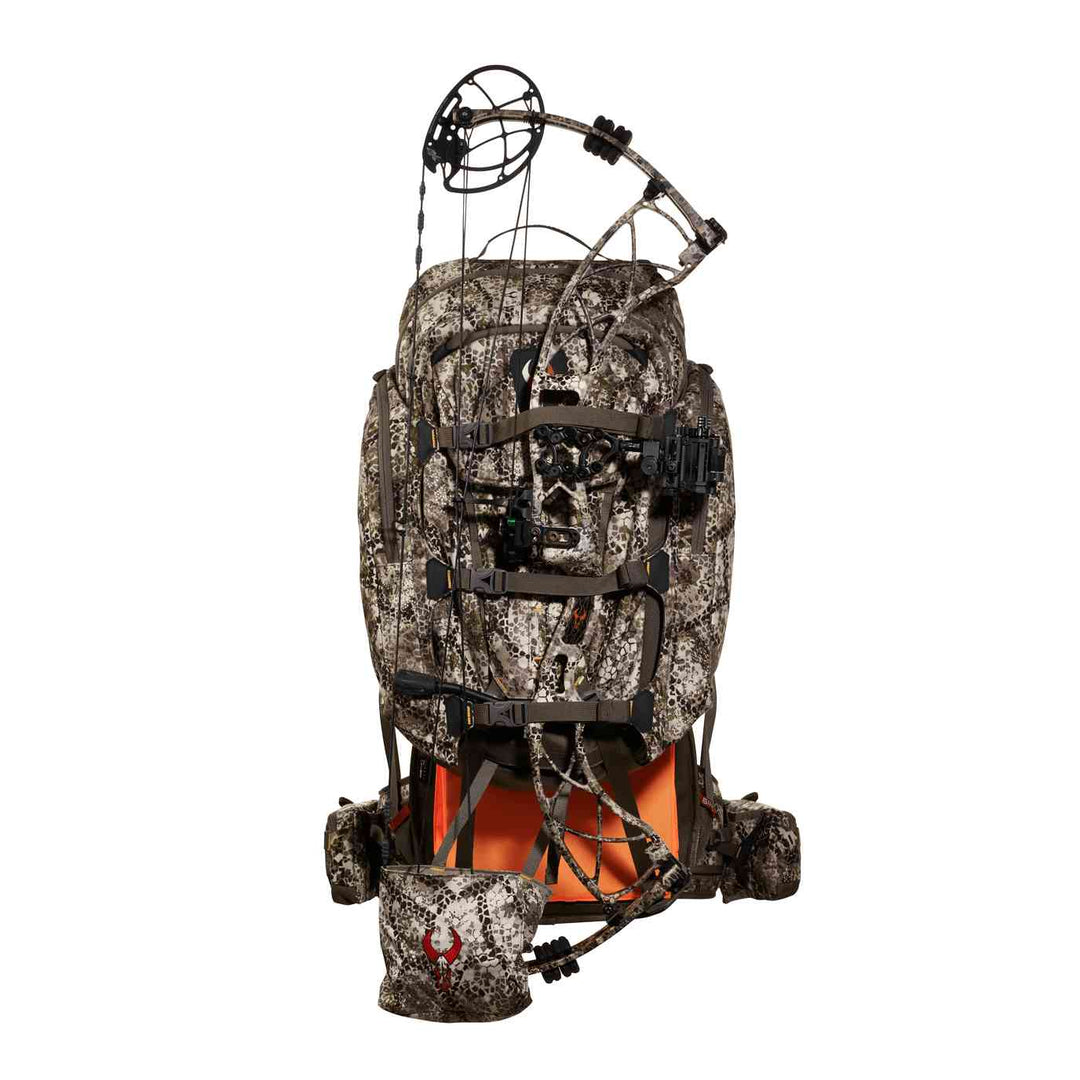Camo Badlands hunting backpack with attached compound bow and visible Badlands skull logo on front pouch.