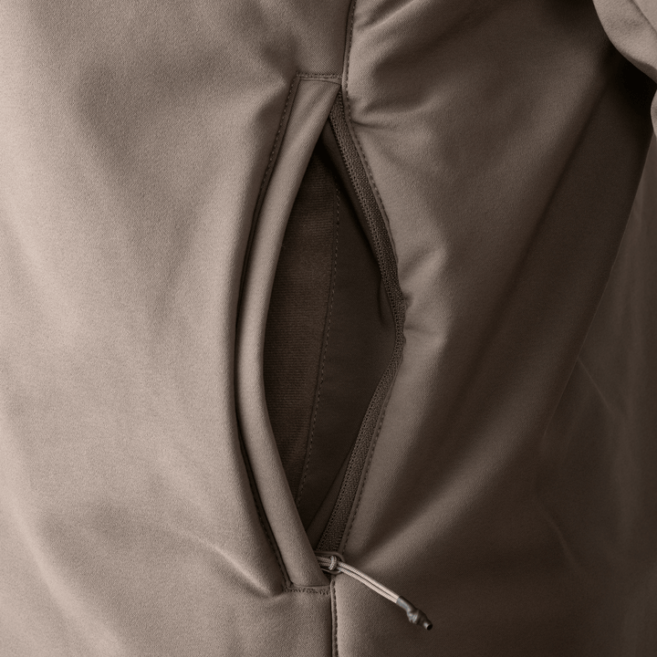Close-up of a Badlands jacket pocket with zipper pull, showing durable fabric and stitching.
