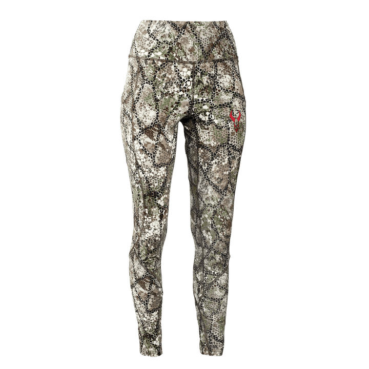 Women's camo leggings with Badlands skull logo on thigh; high-waisted, fitted, and designed for outdoor activities.