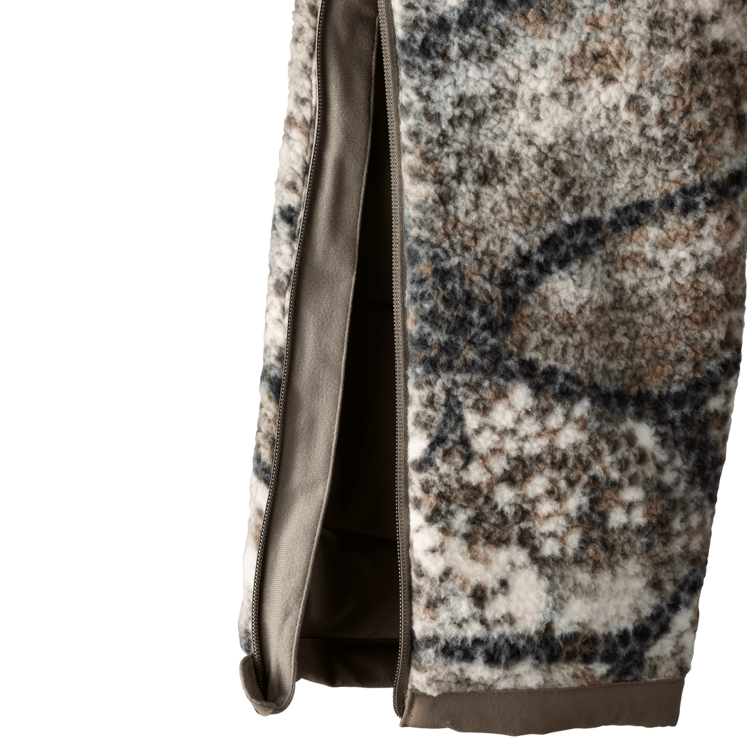 Close-up of Badlands camo fleece fabric with side zipper, showing texture and easy-access opening.