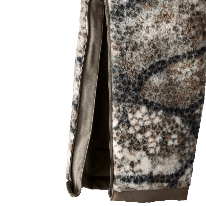 Close-up of Badlands camo fleece fabric with side zipper, showing texture and easy-access opening.