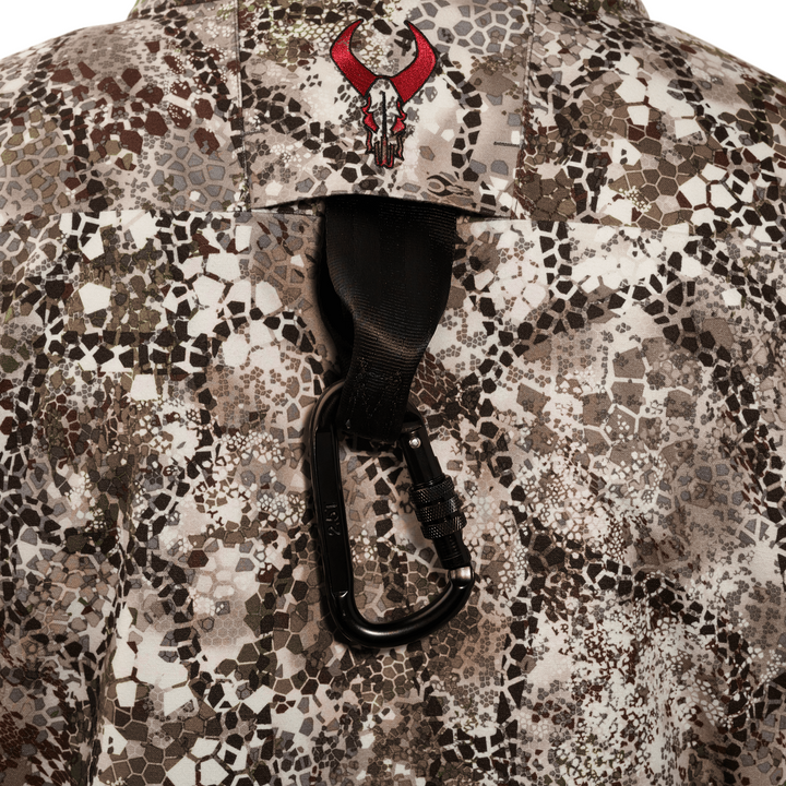 Badlands camo shirt with red skull logo and black carabiner clipped to a loop on the back.