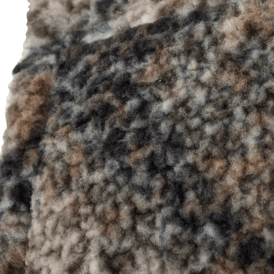 Close-up of Badlands camo fleece fabric showing a soft, textured surface in brown, gray, and black tones.