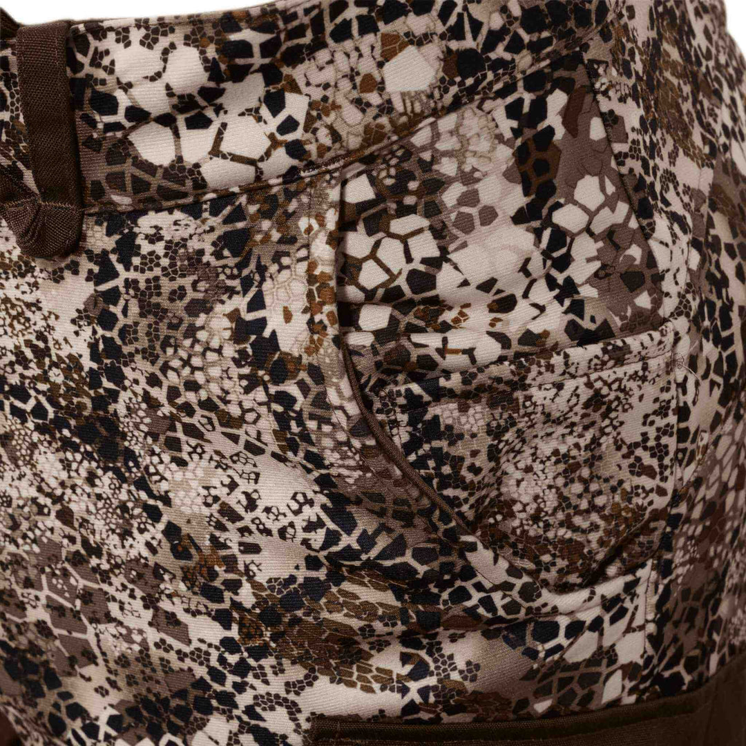 Close-up of Badlands camo pants pocket with textured pattern; skull logo is subtly integrated into the design.