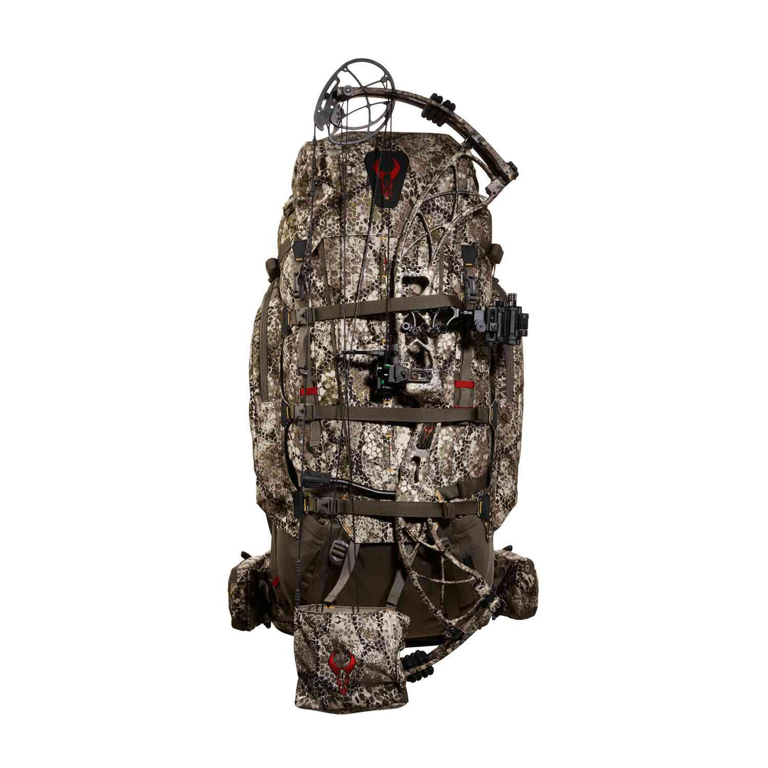 Camo Badlands hunting backpack with bow holder and red skull logo, designed for outdoor and archery gear transport.