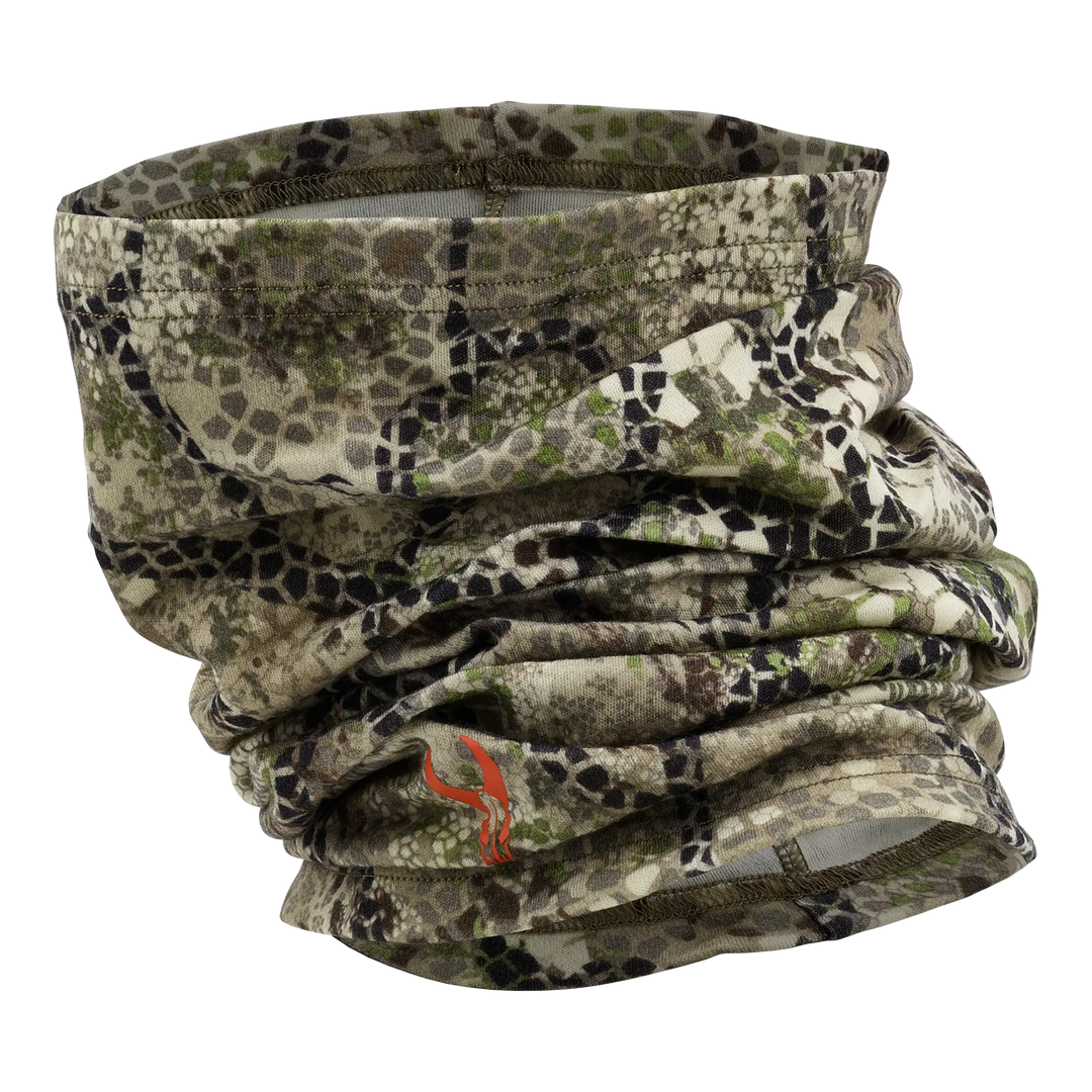 Camo neck gaiter with Badlands skull logo, designed for outdoor use; earth tones and flexible fabric.
