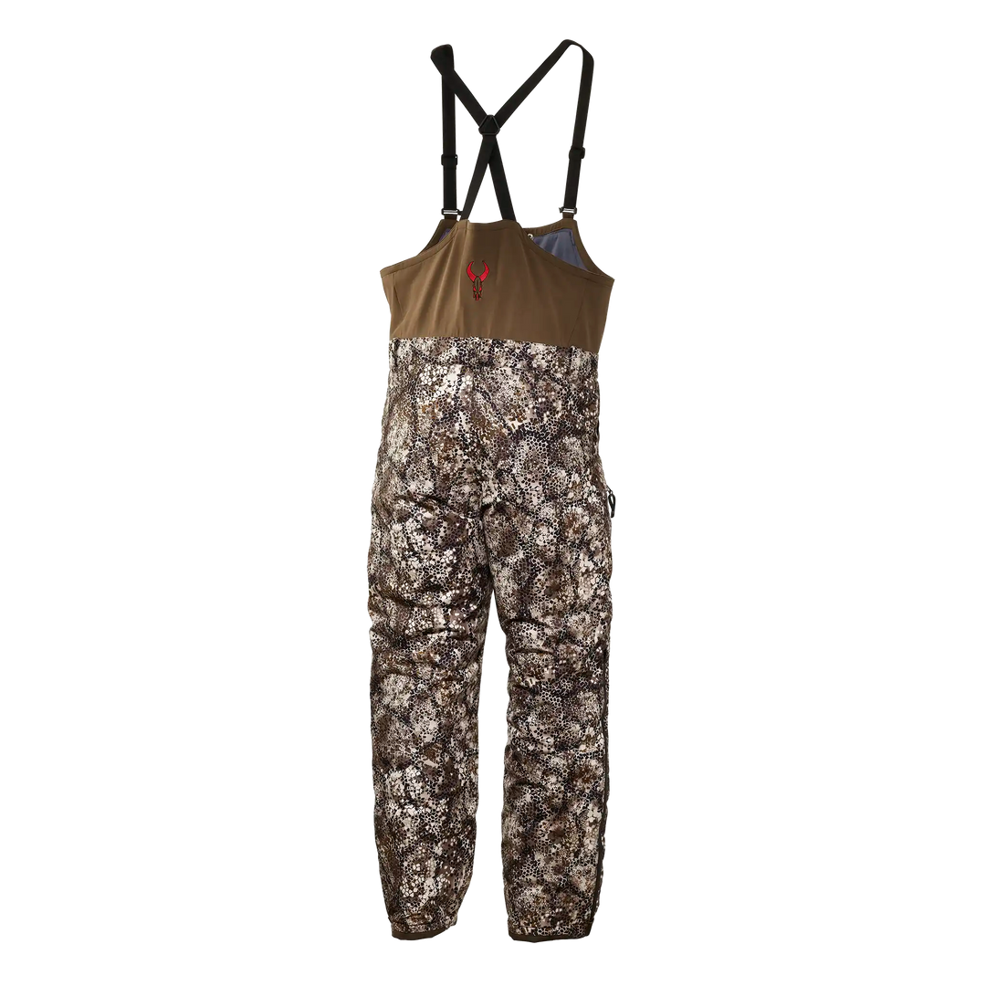Badlands camo hunting bib with adjustable straps and red skull logo on chest.
