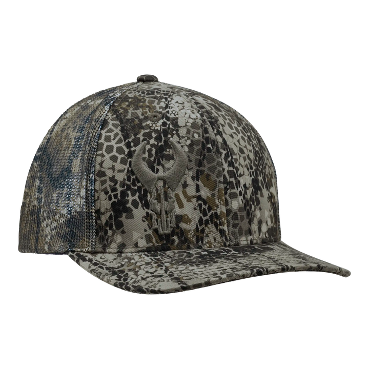 Camo-patterned Badlands cap with embroidered skull logo on front, structured crown, and curved bill.