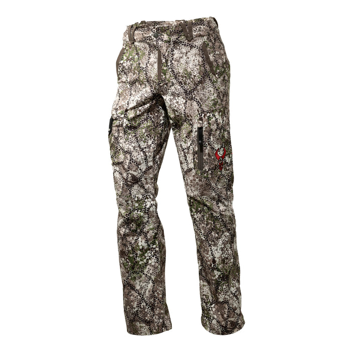 Badlands camo hunting pants with zippered pockets and red skull logo on thigh, shown on white background.
