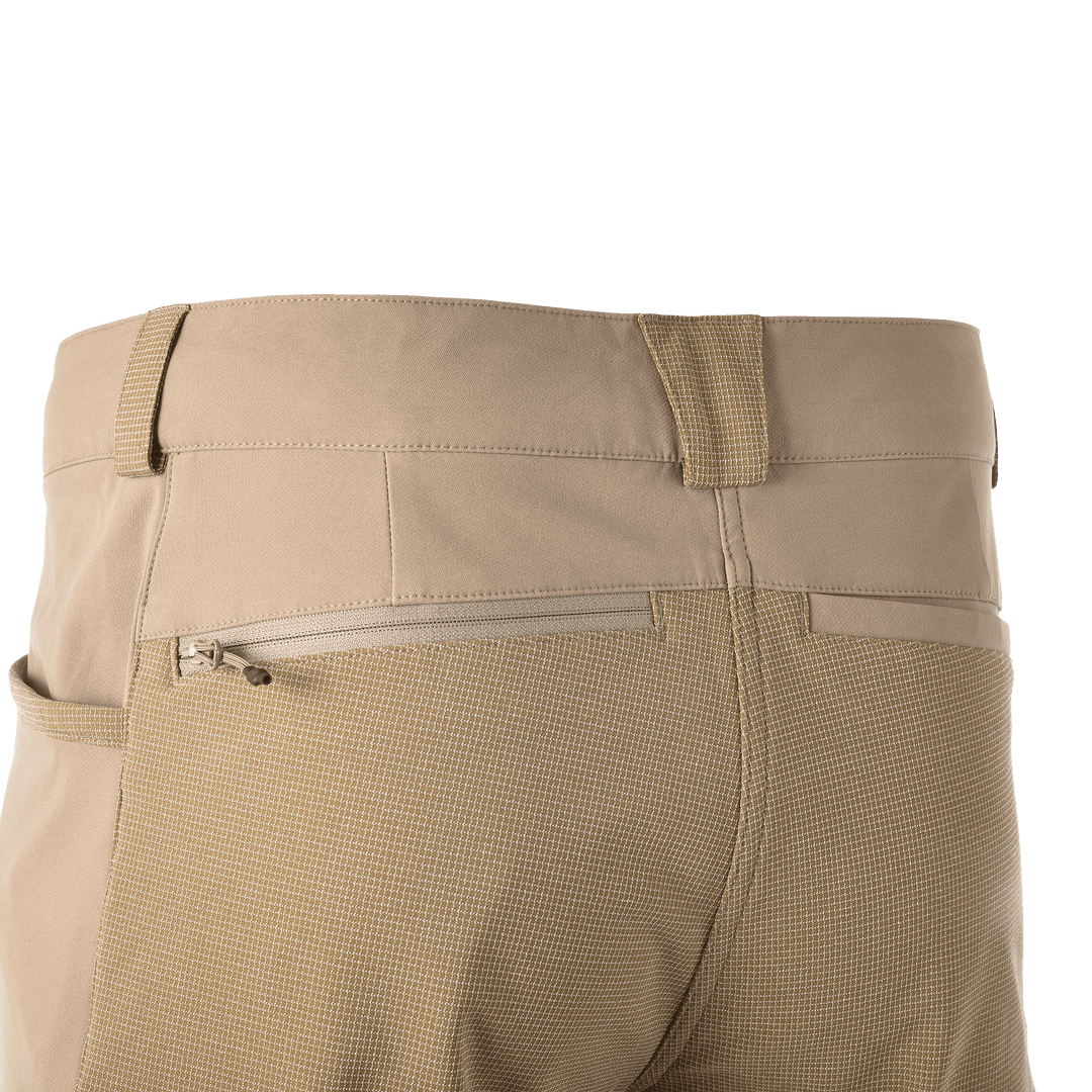 Back view of tan Badlands pants with textured fabric, zippered pocket, and reinforced belt loops.