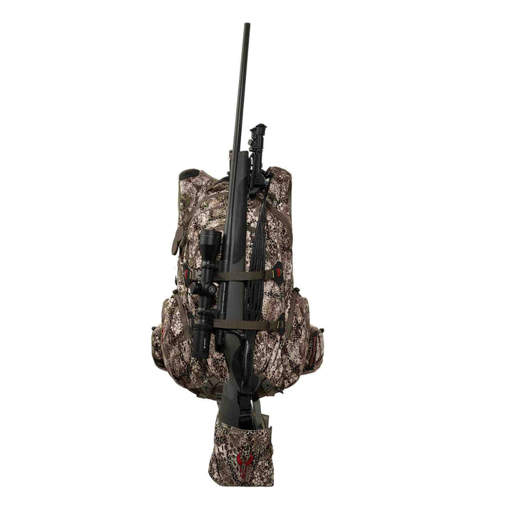 Badlands camo hunting backpack with rifle holder and red Badlands skull logo on the bottom pouch, shown on white background.