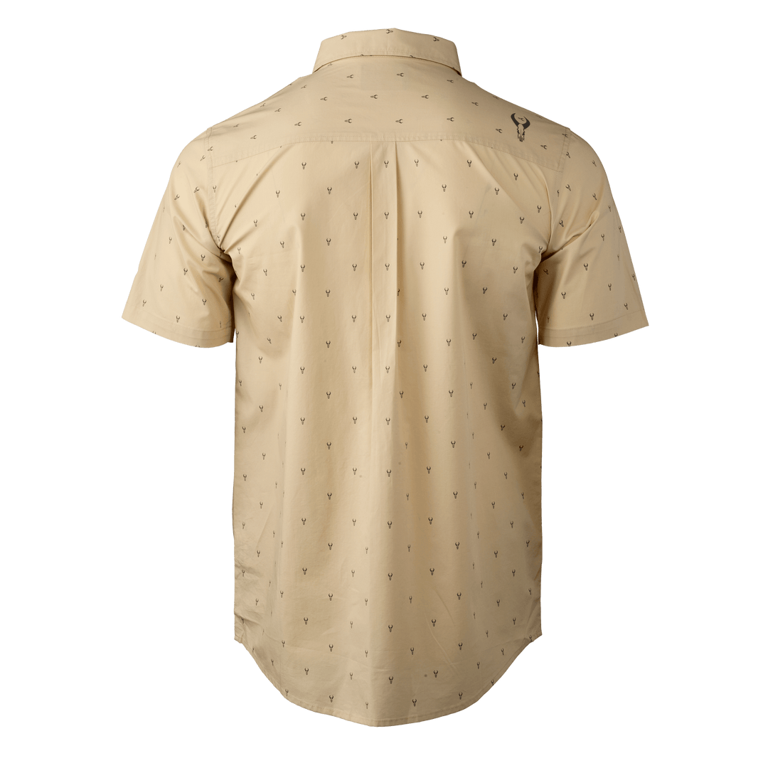 Tan short-sleeve shirt with subtle antler print and Badlands skull logo on upper back.