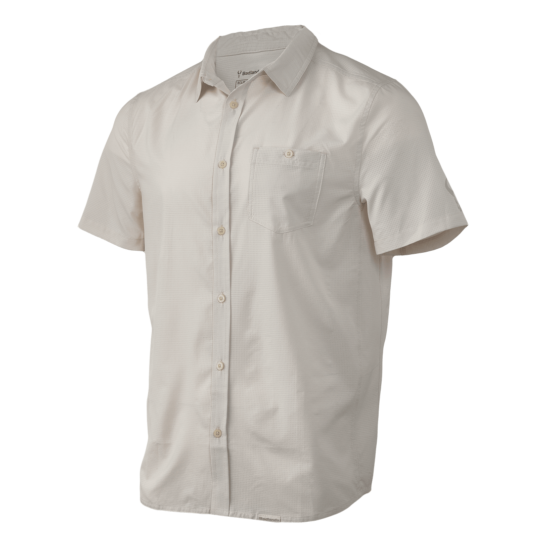 Light tan Badlands short-sleeve button-up shirt with chest pocket and subtle skull logo on the sleeve.