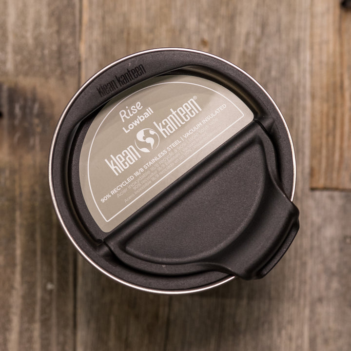 Top view of a Klean Kanteen Rise Lowball cup with lid, on a rustic wood surface. No Badlands logo visible.