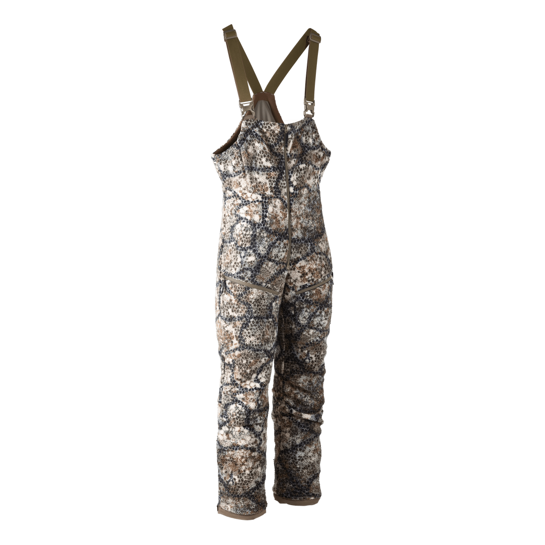 Badlands camo hunting bib with adjustable straps, front zipper, and logo skull patch; designed for outdoor use.