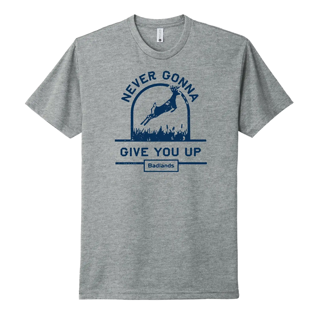Gray Badlands shirt with deer, "Never Gonna Give You Up" text, and Badlands skull logo below in blue.