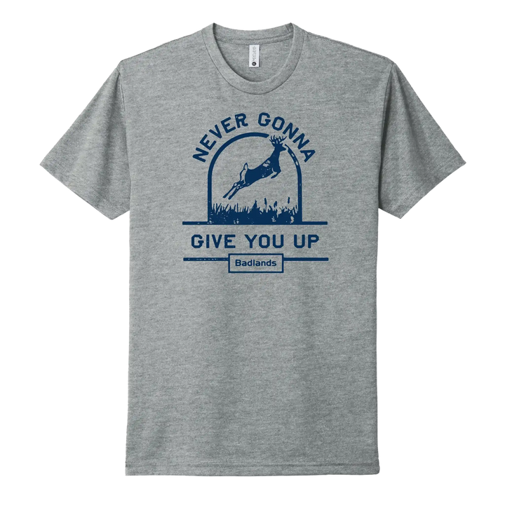 Gray Badlands shirt with deer, "Never Gonna Give You Up" text, and Badlands skull logo below in blue.