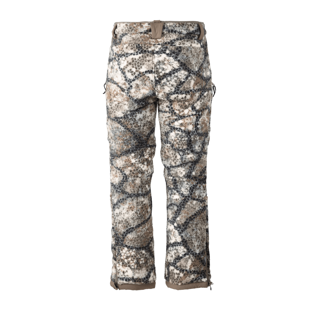 Badlands camo hunting pants with neutral tones and signature skull logo on waistband, designed for outdoor concealment.