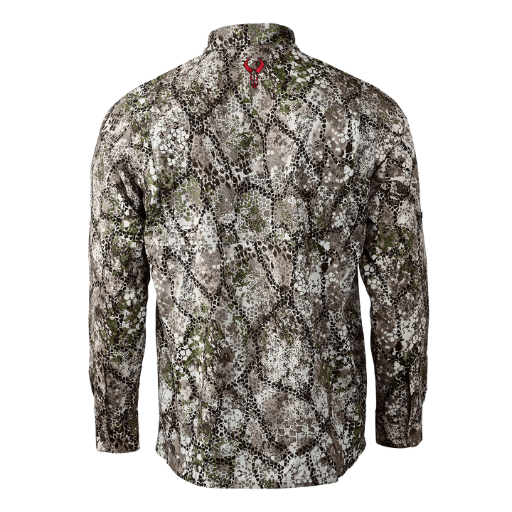 Back view of Badlands camo shirt with red skull logo at neck; earth-tone pattern for outdoor concealment.