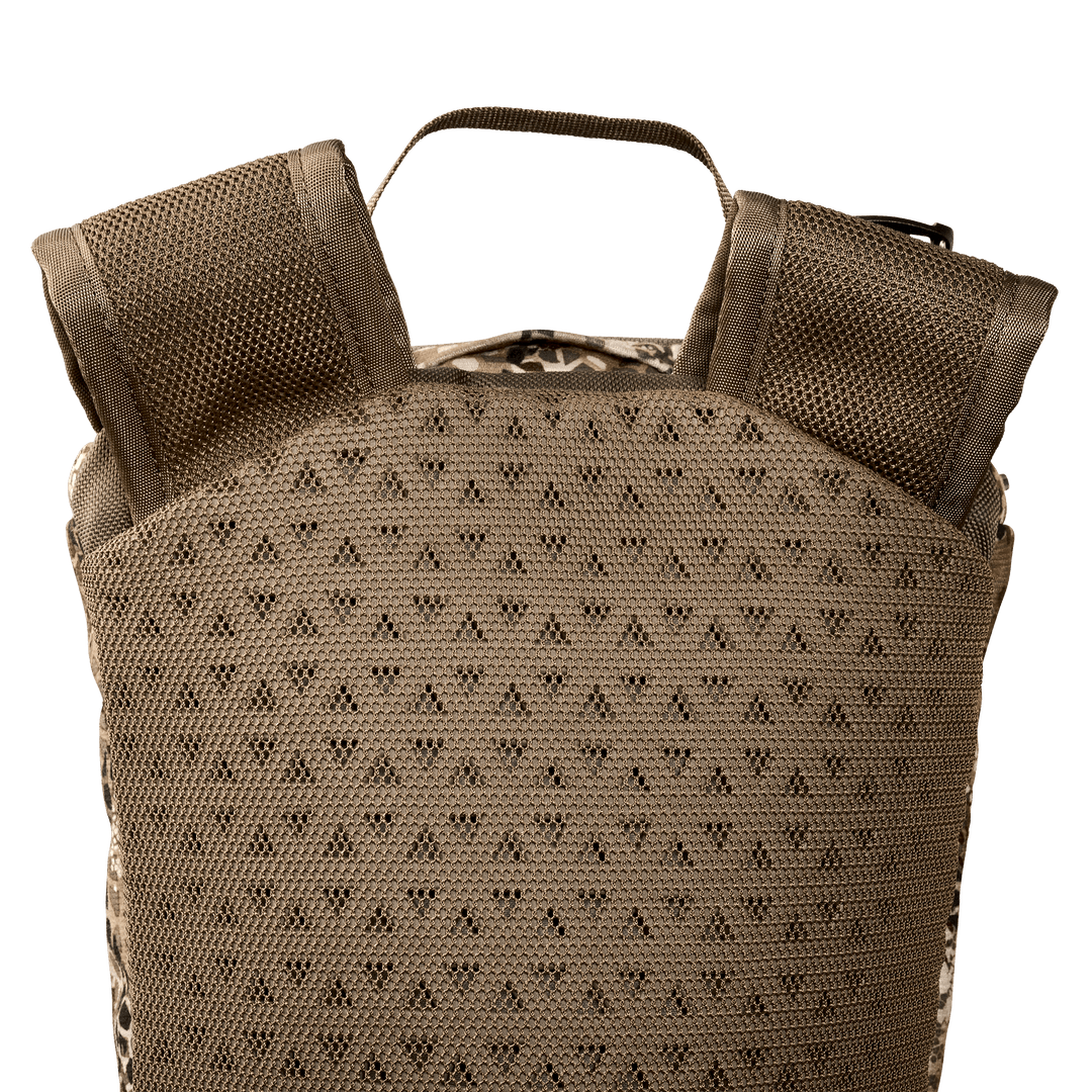 Close-up of a Badlands backpack’s padded, breathable back panel and shoulder straps in tan color.