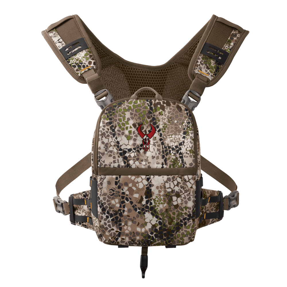 Badlands camo binocular harness with red skull logo, adjustable straps, and mesh backing for comfort.