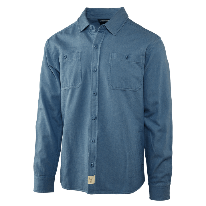 Blue Badlands long-sleeve shirt with two chest pockets and skull logo tag at hem, front view.