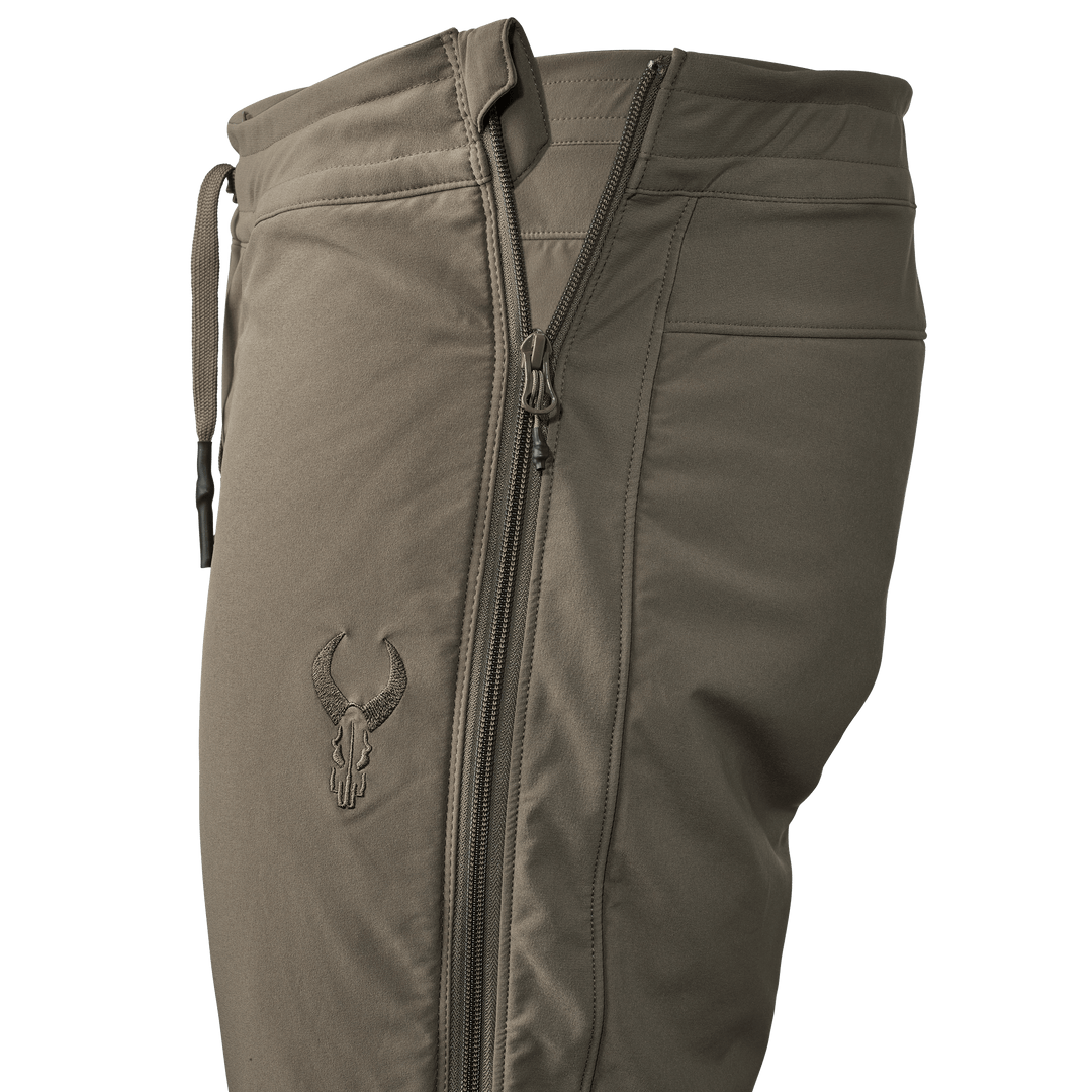 Tan Badlands pants with side zipper and embroidered Badlands skull logo on the thigh.